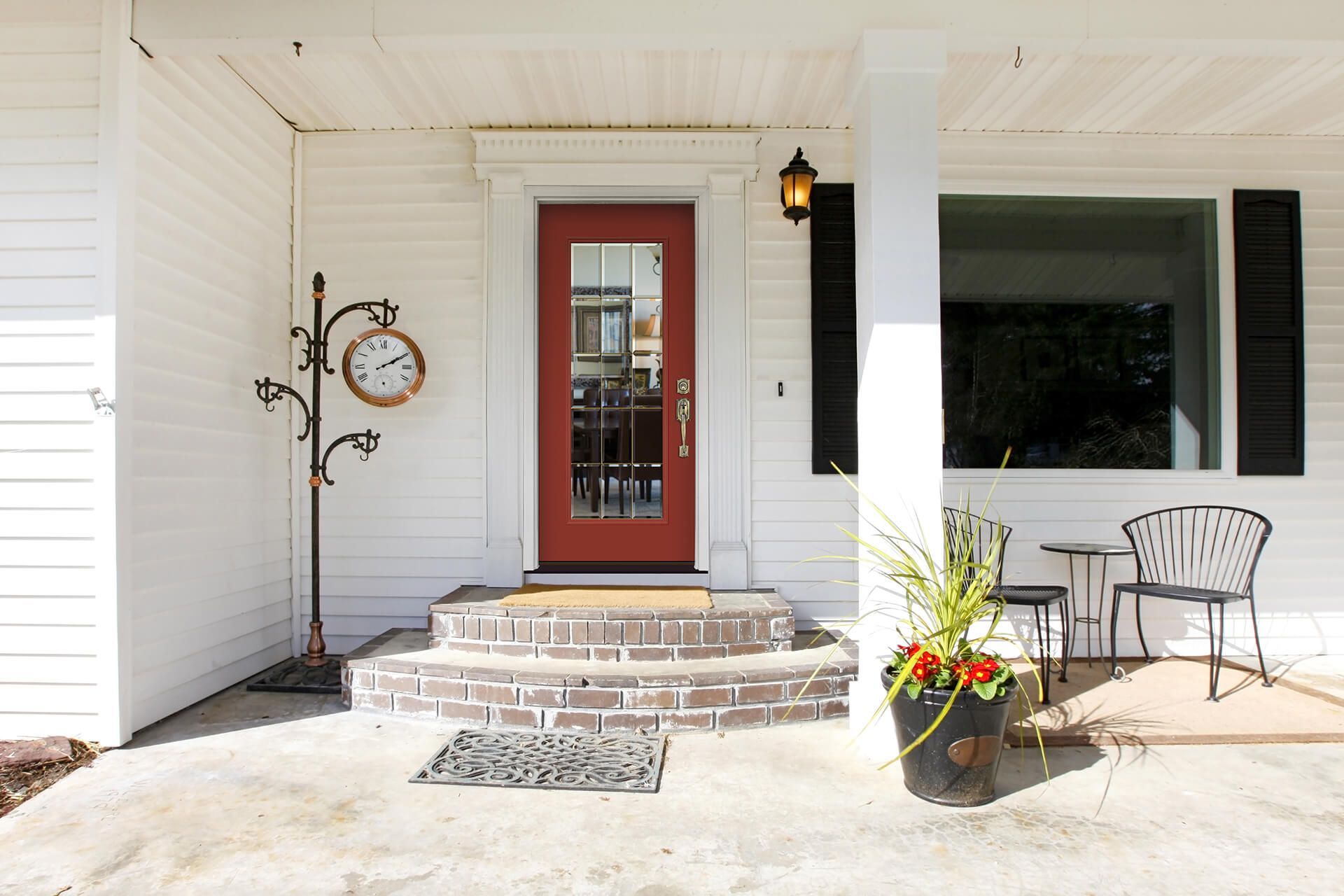Spacious open-concept living room with gray sectional, rug, and coffee table, leading to kitchen and dining area.