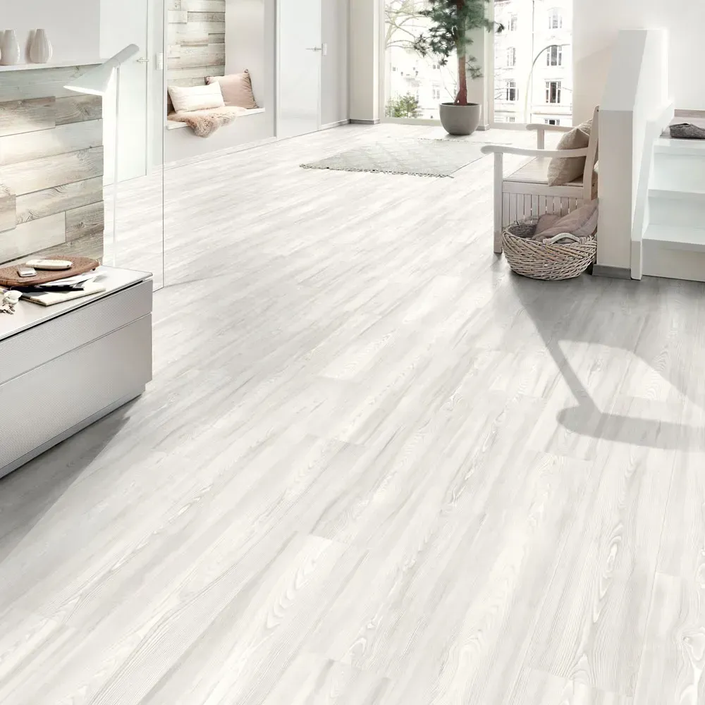White wood-look flooring in a bright, modern interior.