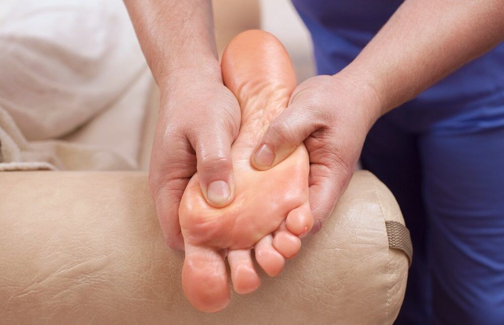A Person Is Giving A Foot Massage To Another Person — Lake Macquarie Podiatry in Belmont, NSW
