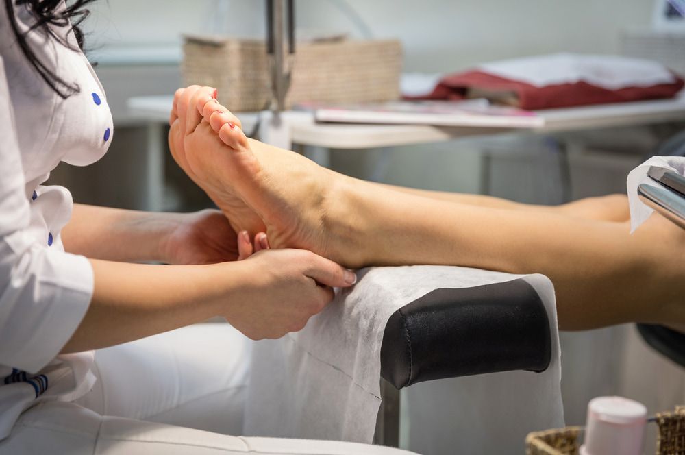 A Woman Is Getting A Foot Massage — Lake Macquarie Podiatry in Belmont, NSW