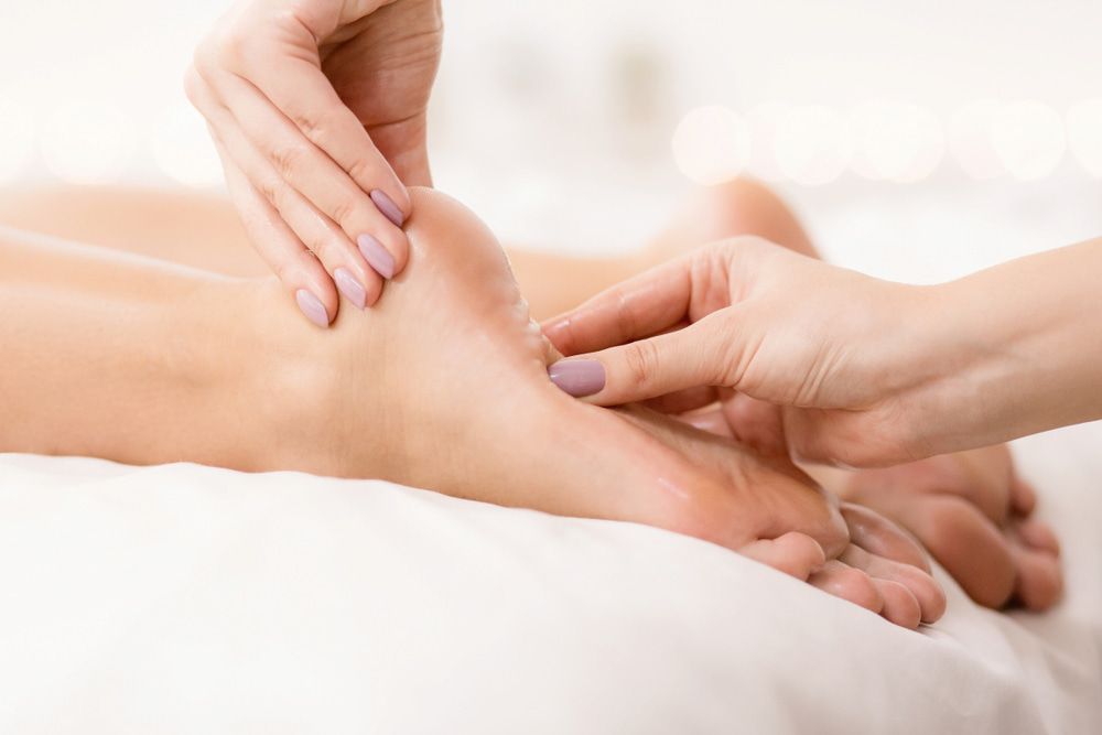 A Woman Is Getting A Foot — Lake Macquarie Podiatry in Belmont, NSW