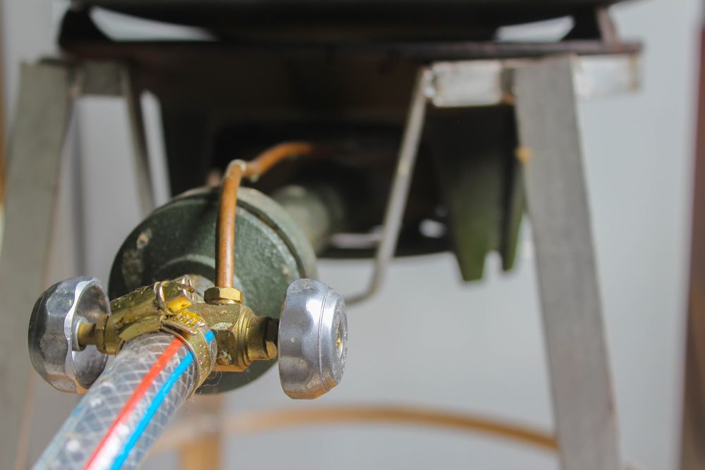 A Close Up of a Gas Hose Attached to a Stove — Gastech Plumbing Services in Andergrove, QLD