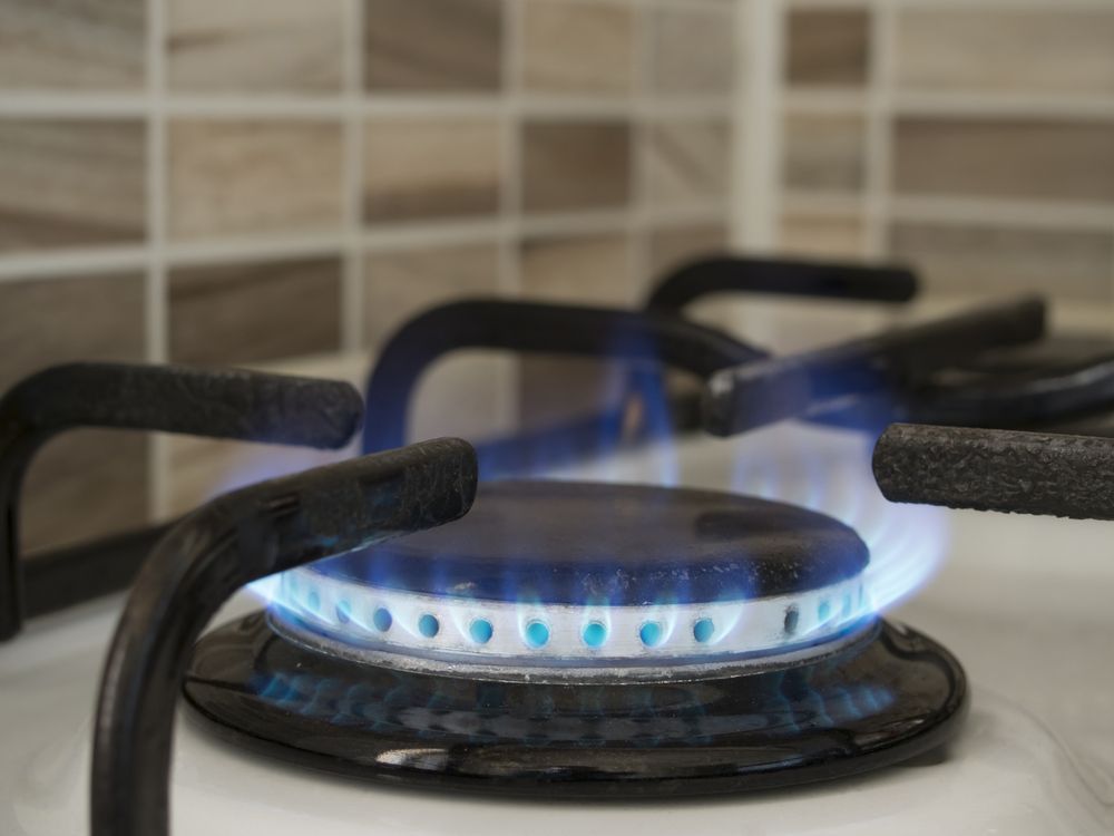 A Close Up of a Gas Stove With a Blue Flame Coming Out of It — Gastech Plumbing Services in Andergrove, QLD