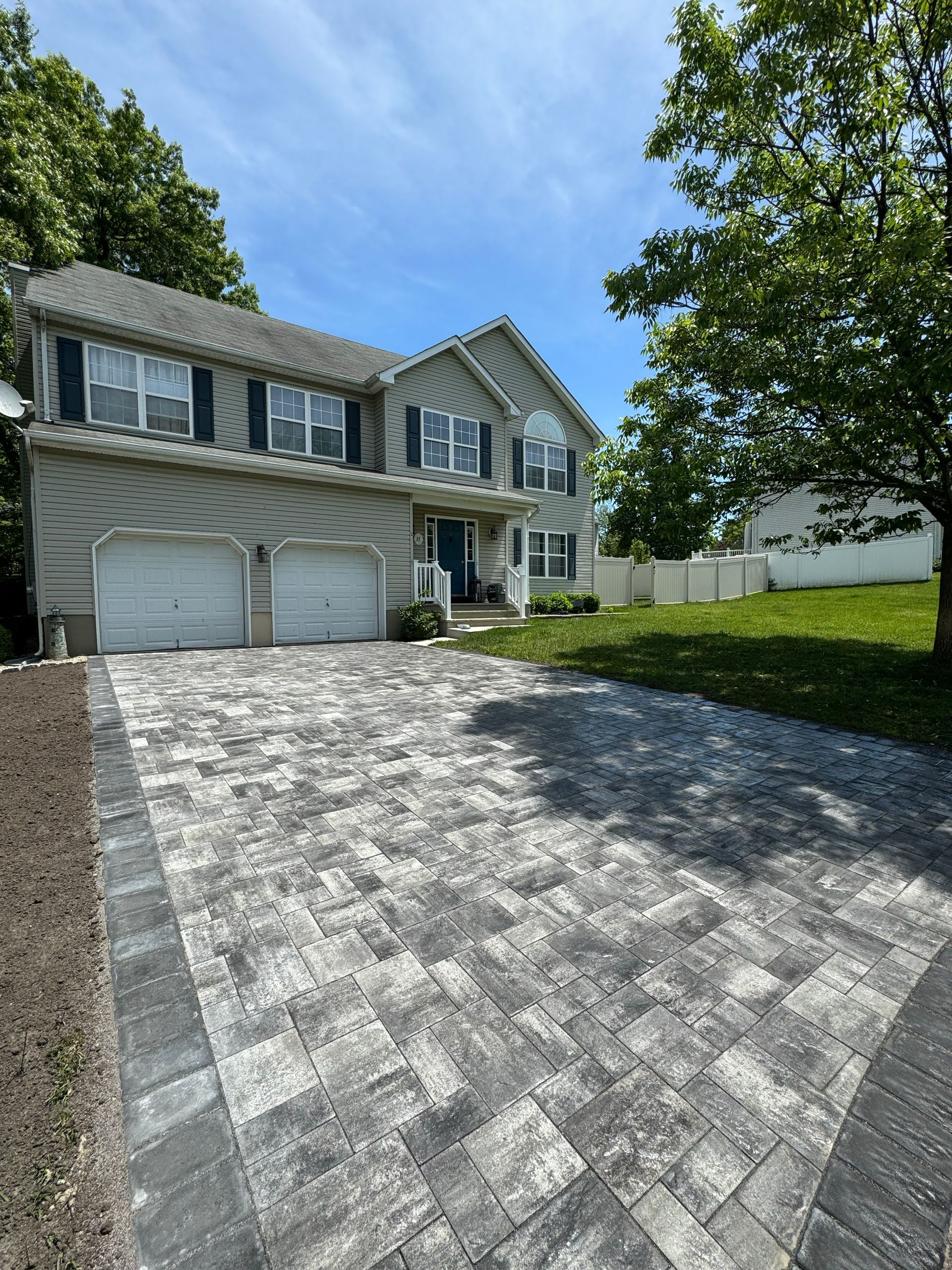 Residential home with landscaped front yard and mature trees