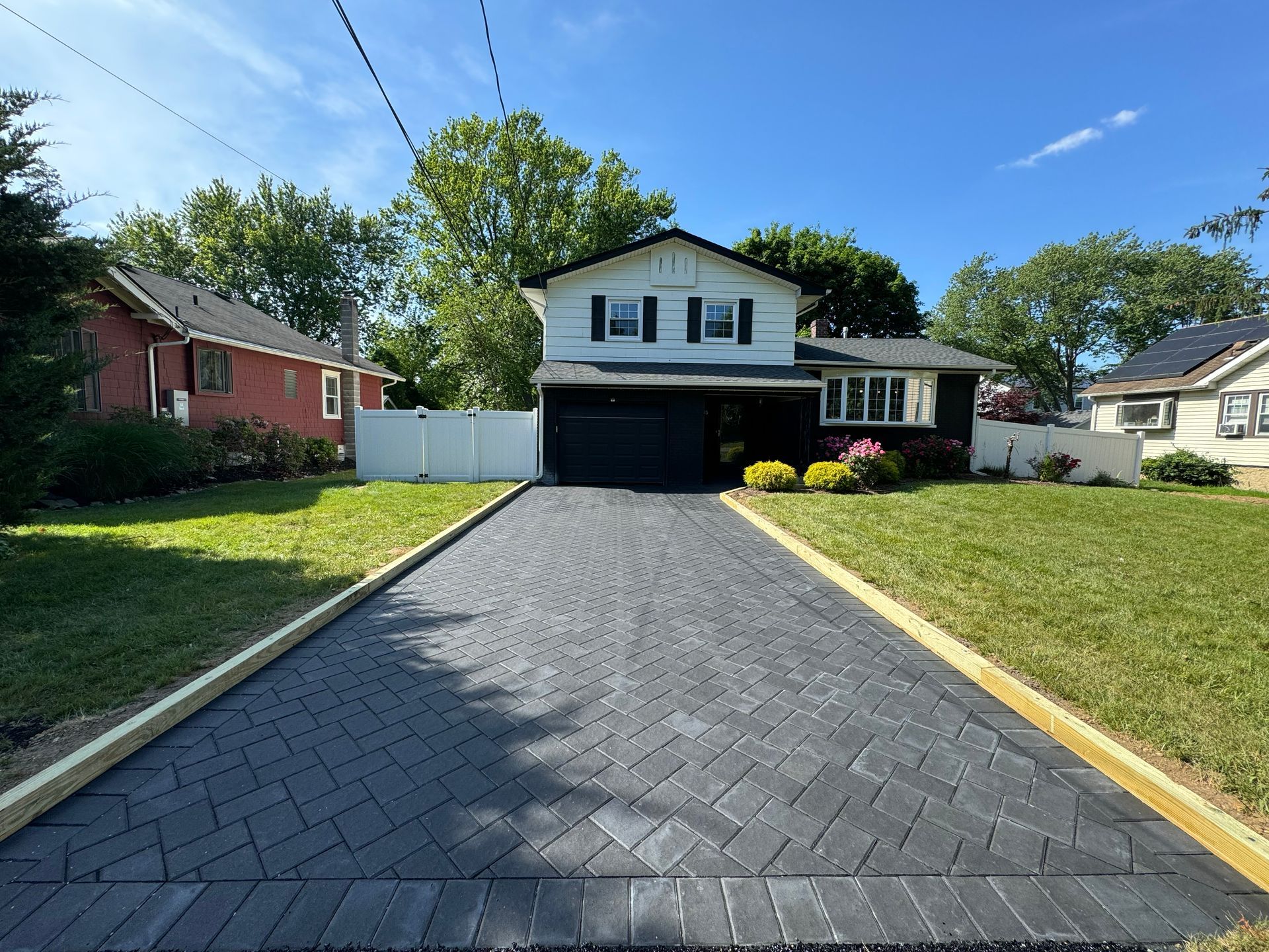 Paver driveway installation leading to residential garage