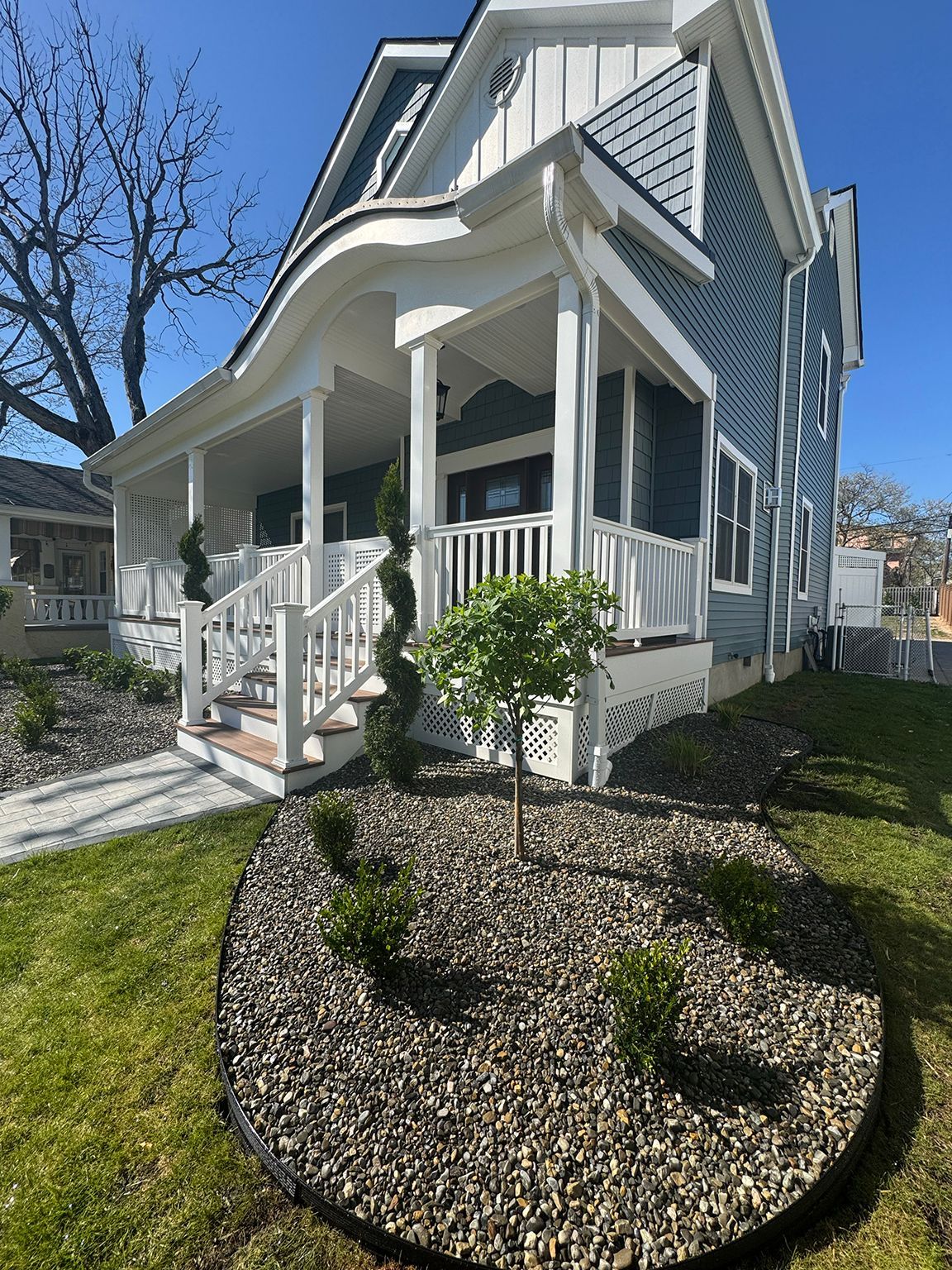Residential home exterior with landscaped front yard and porch