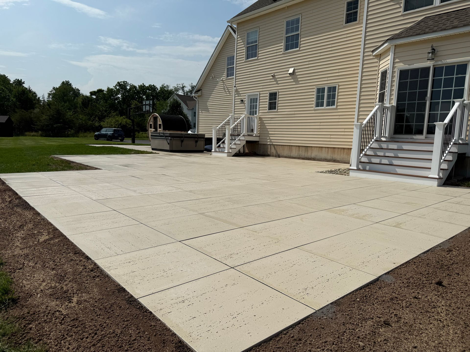 Concrete patio installation for backyard outdoor living space