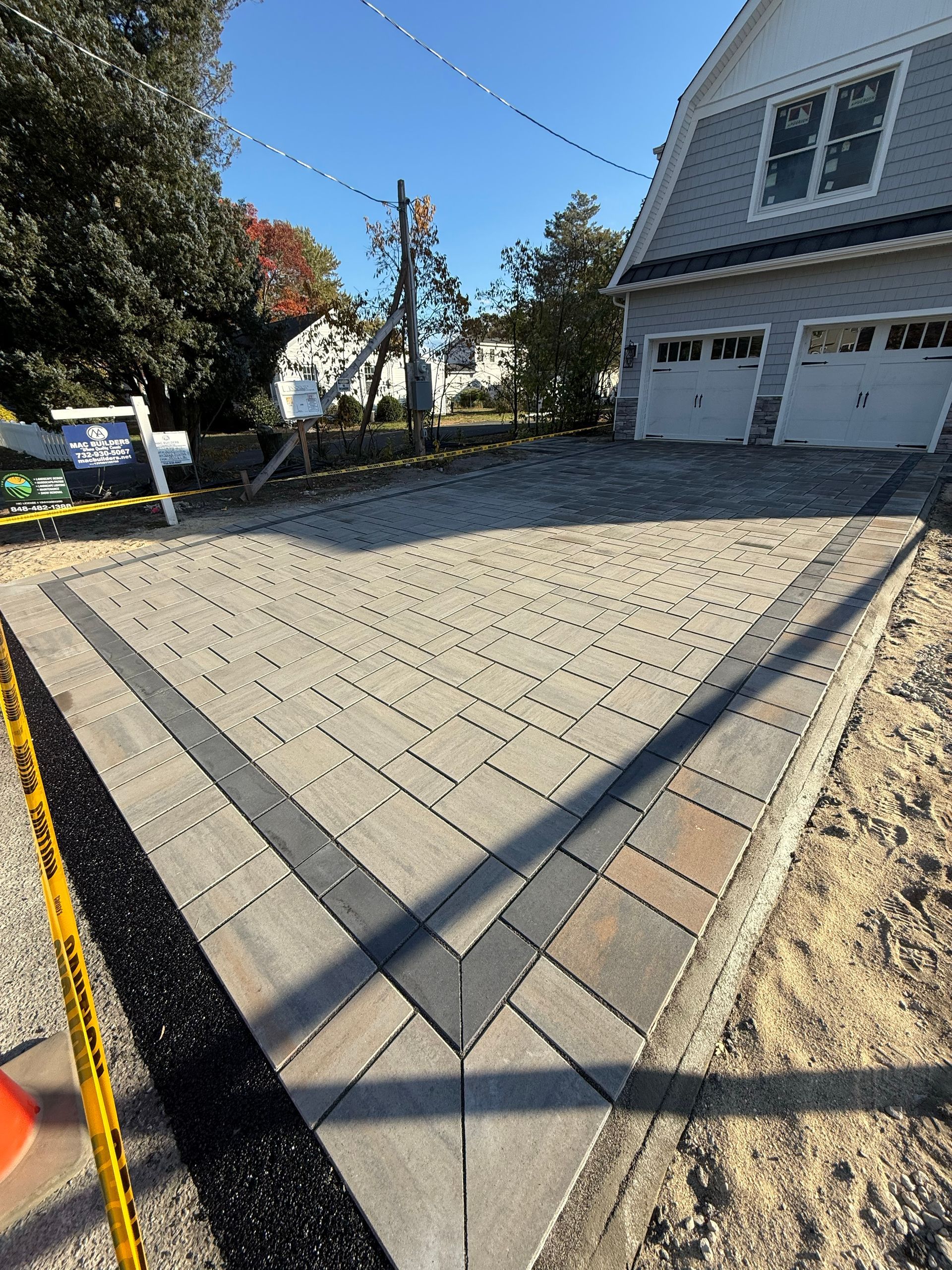 Residential driveway installation with paver and concrete work