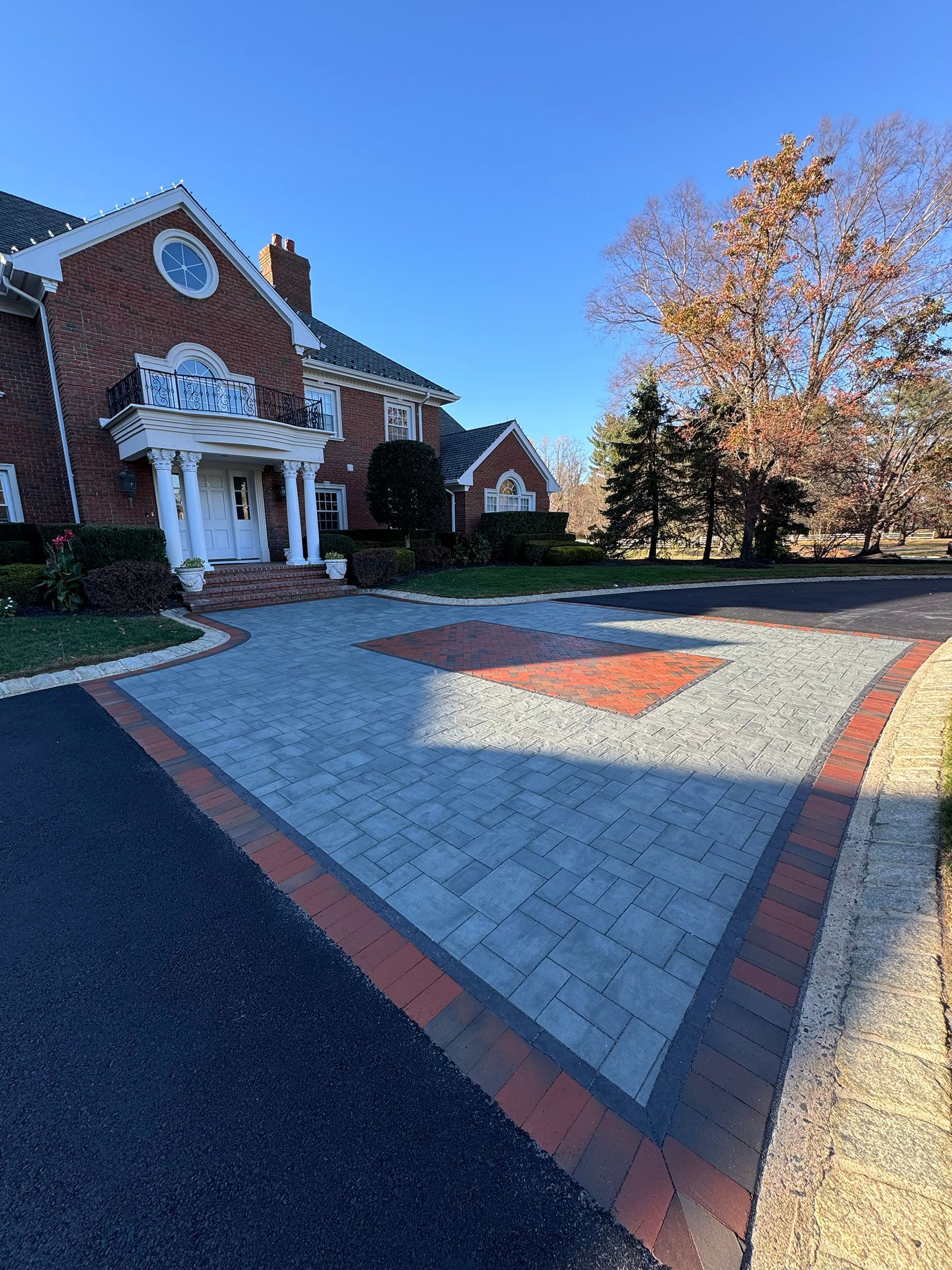 Front yard landscaping with planting beds and mature trees