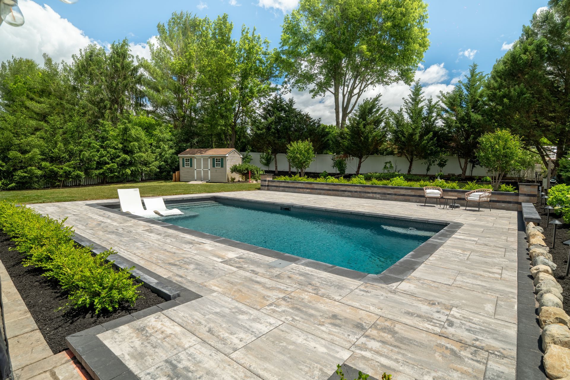 Circular paver patio with built-in fire pit and seating area