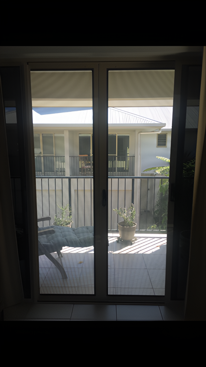 Sliding Glass Door With Screen Overlooking a Patio — All Security Screens & Repairs In Bungalow, QLD