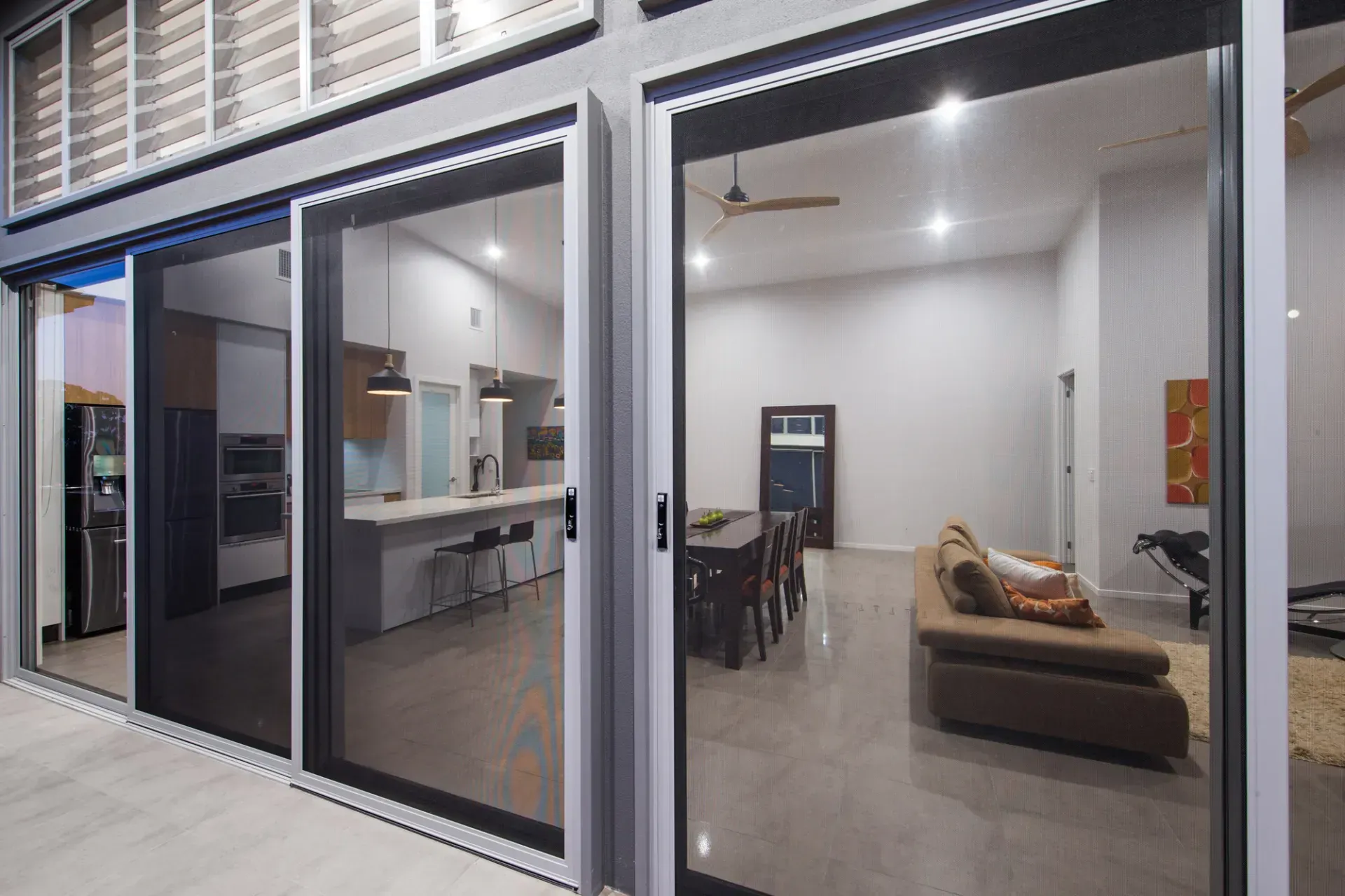 Large Glass Sliding Doors Open to a Modern Home's Interior — All Security Screens & Repairs In Bungalow, QLD