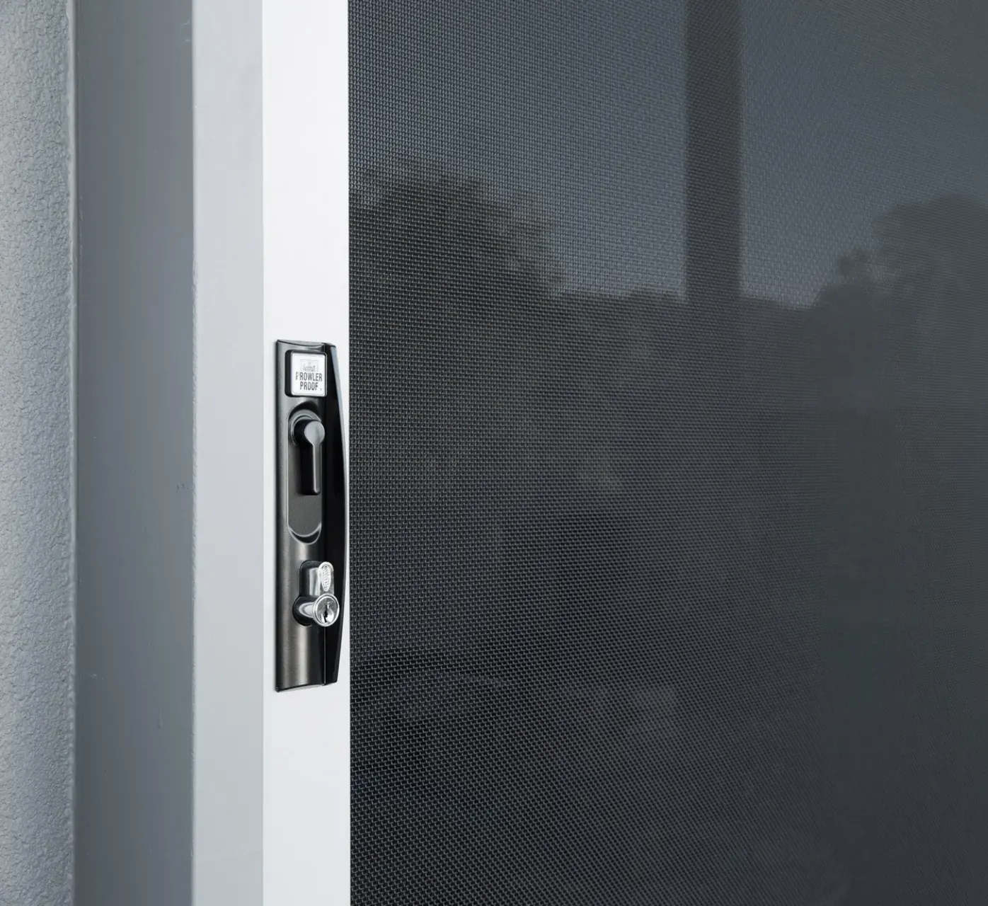 Hands Installing a Door Latch Into a Wooden Door — All Security Screens & Repairs In Bungalow, QLD