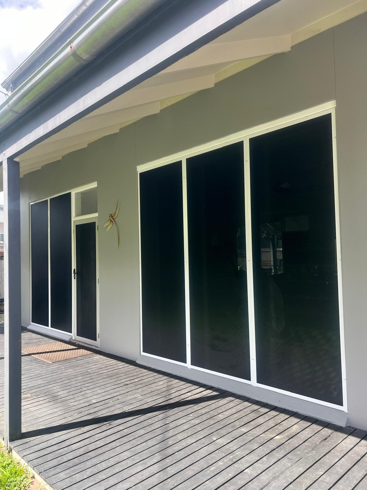 Gray House Exterior With Black Screened Windows — All Security Screens & Repairs In Bungalow, QLD
