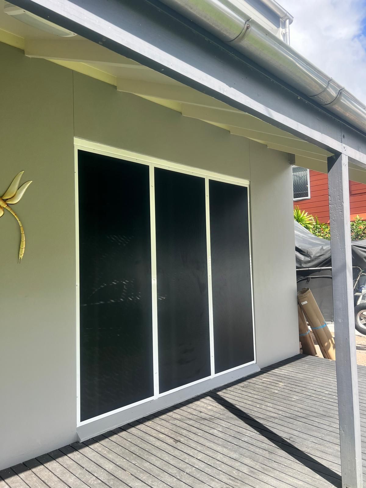 Gray Exterior Wall With a Large, Black-paneled Window Framed — All Security Screens & Repairs In Bungalow, QLD