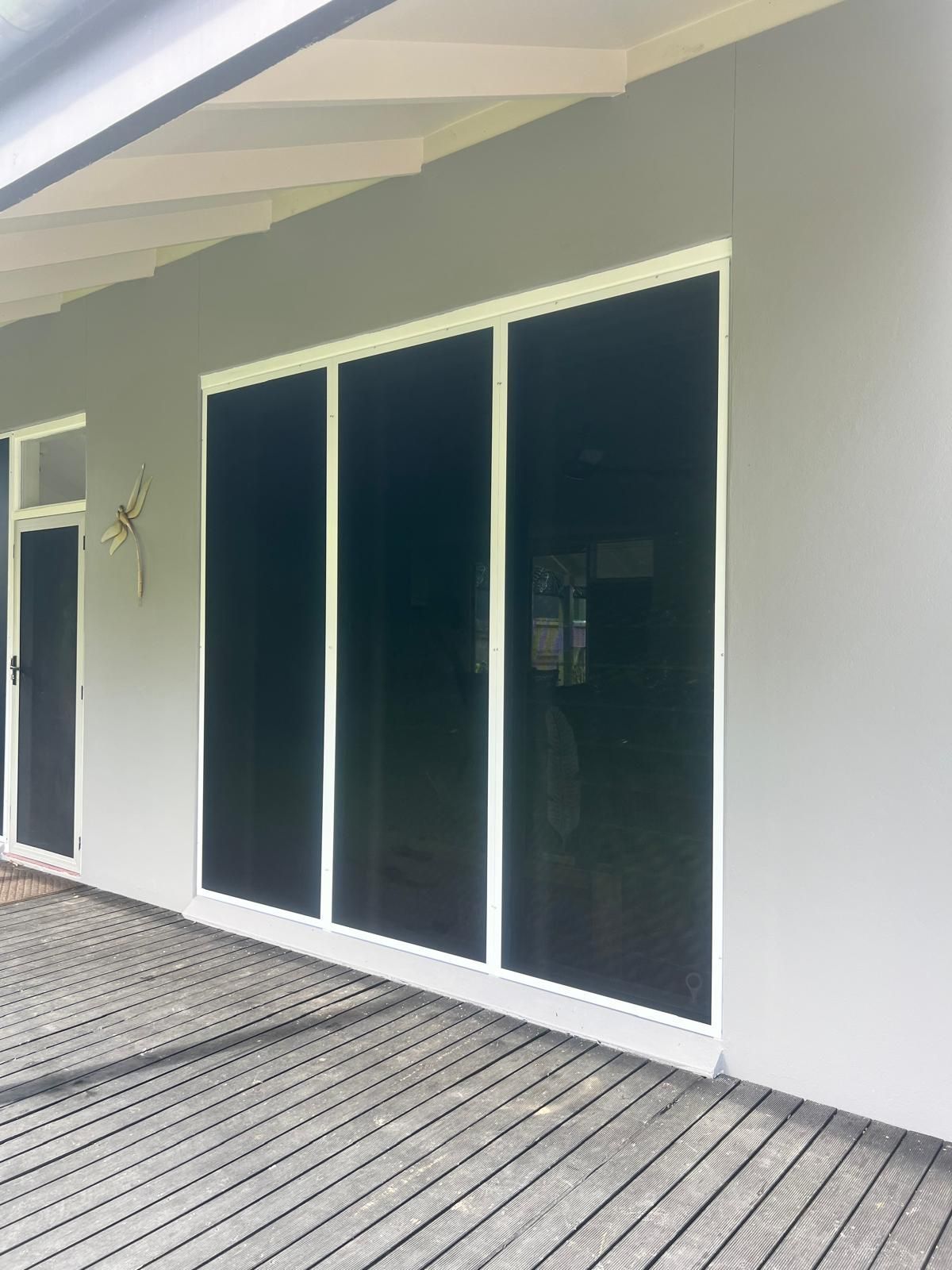 Sliding Glass Doors With White Frames and Dark Tinting — All Security Screens & Repairs In Bungalow, QLD