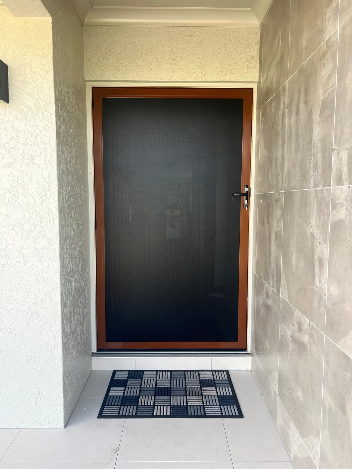 Brown-framed Screen Door on a White Porch — All Security Screens & Repairs In Bungalow, QLD
