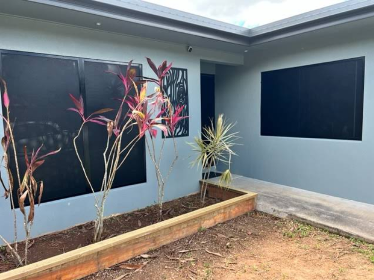 Maroon Front Door With Screen, White Trim, Beige Siding, and Brick Step — All Security Screens & Repairs In Bungalow, QLD