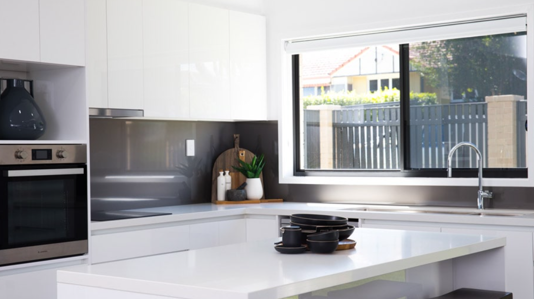 Family Eating at a Table, Screened Door Open to Interior With Stairs — All Security Screens & Repairs In Bungalow, QLD
