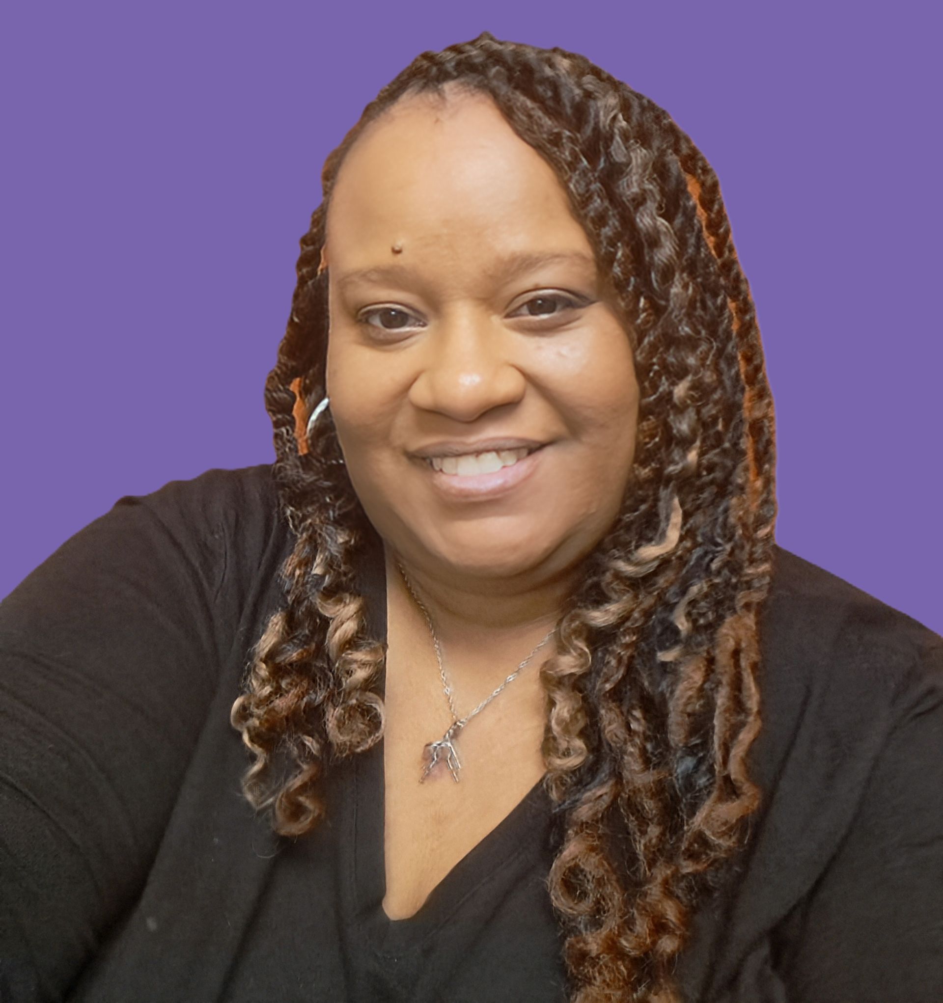 A woman with dreadlocks is wearing a black shirt and a necklace