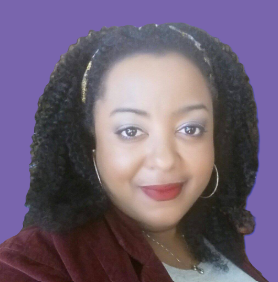 A woman with curly hair is wearing a headband and earrings.