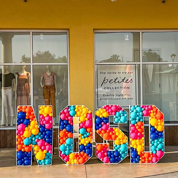 A store front with a sign that says petite collection