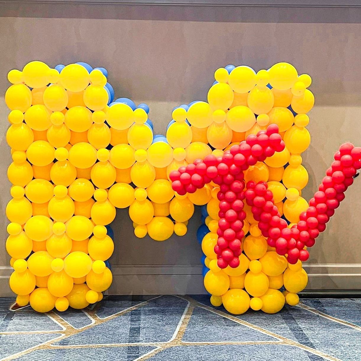 The sign mtv is made out of yellow and red balloons