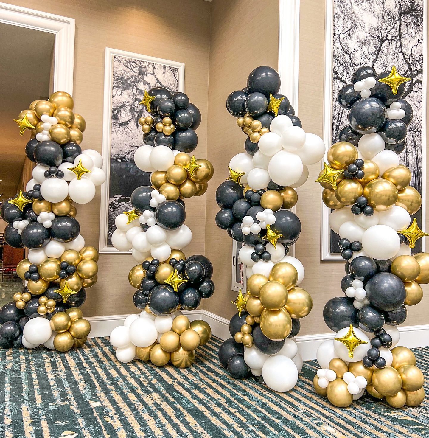 A bunch of balloons are stacked on top of each other in a room.