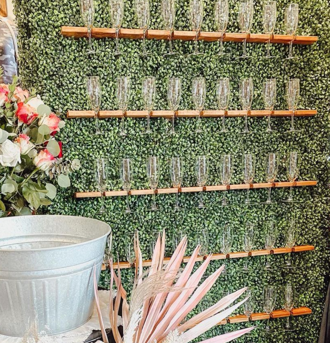 a wall with a bunch of wine glasses hanging from it
