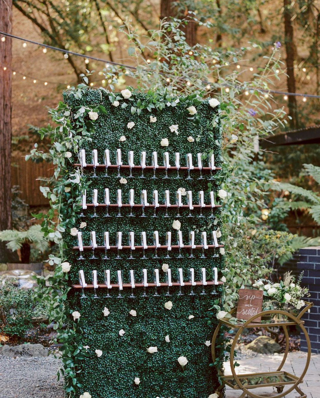 a wall with lots of wine glasses hanging from it