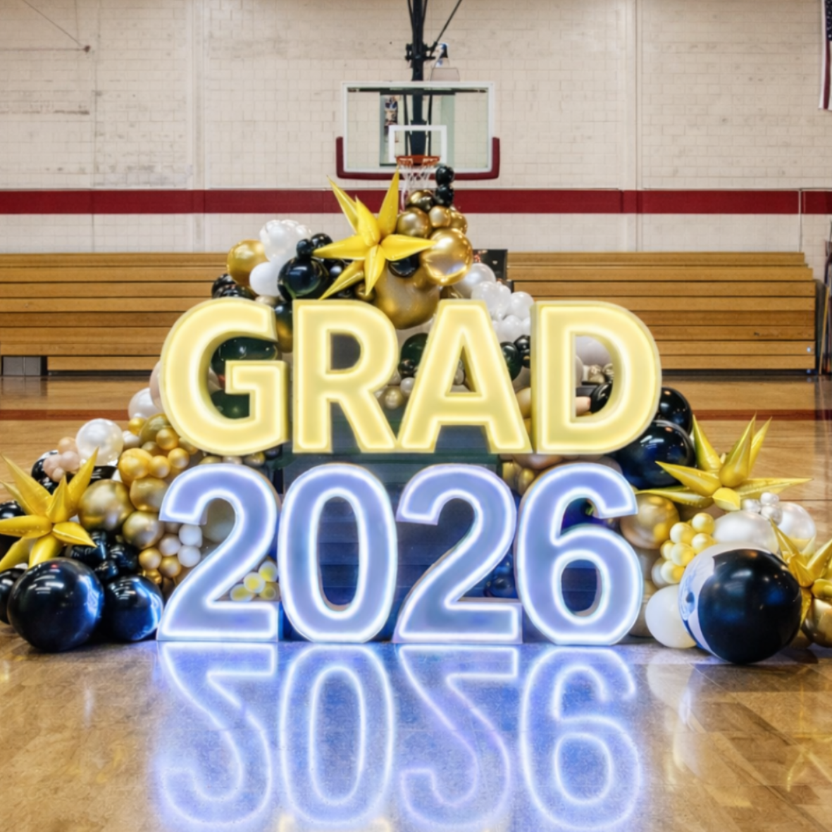 The word baby is surrounded by pink and blue balloons.