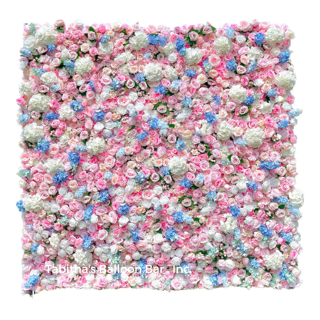 a wall of pink , white and blue flowers on a white background .