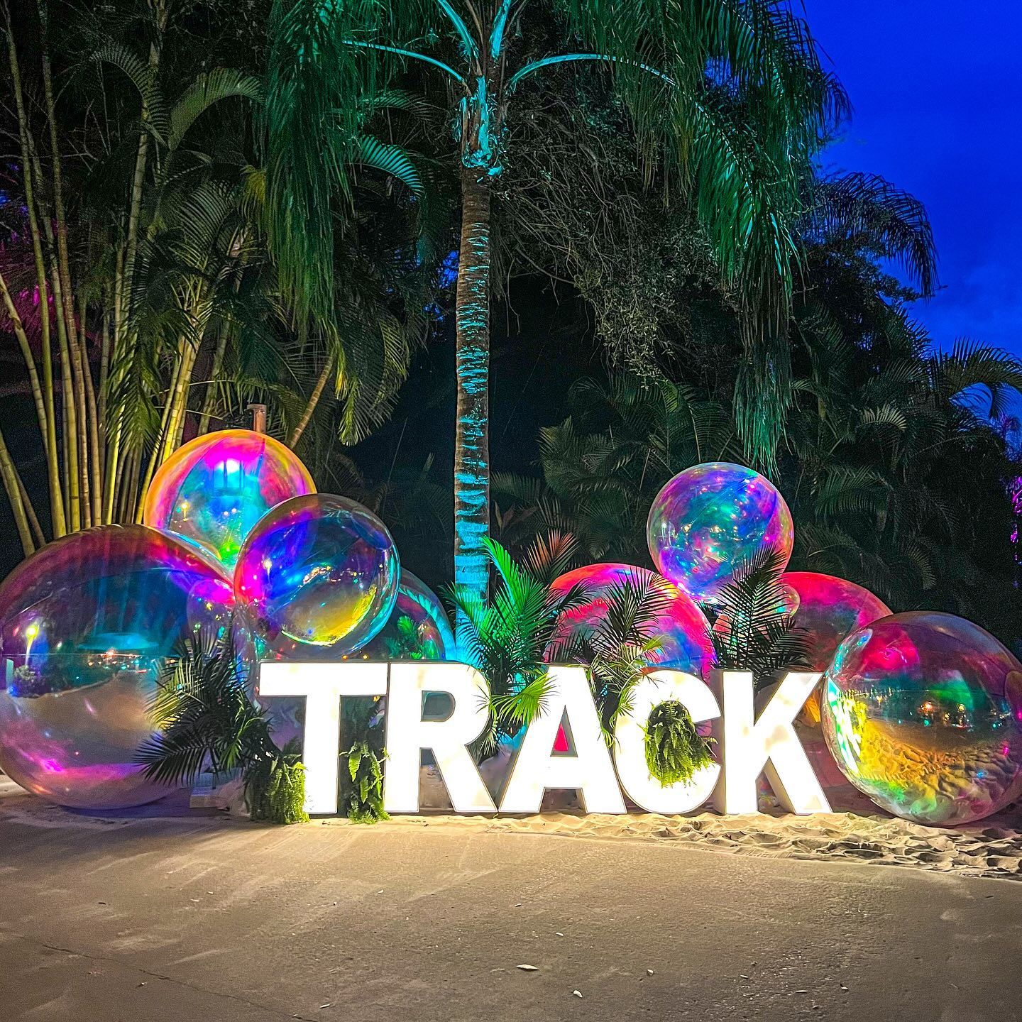 A large sign that says track is surrounded by balloons.