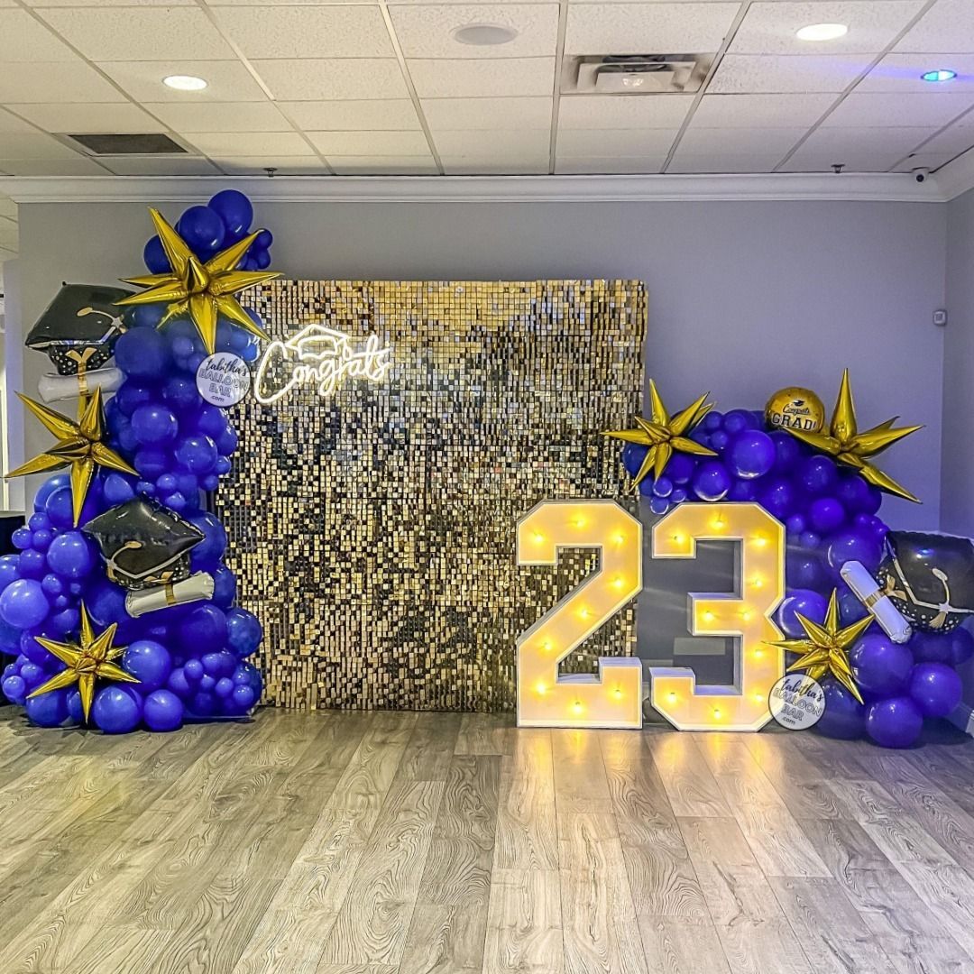 A room filled with balloons and a sign that says `` 23 ''.