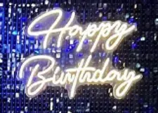 a neon sign that says `` happy birthday '' on a blue background