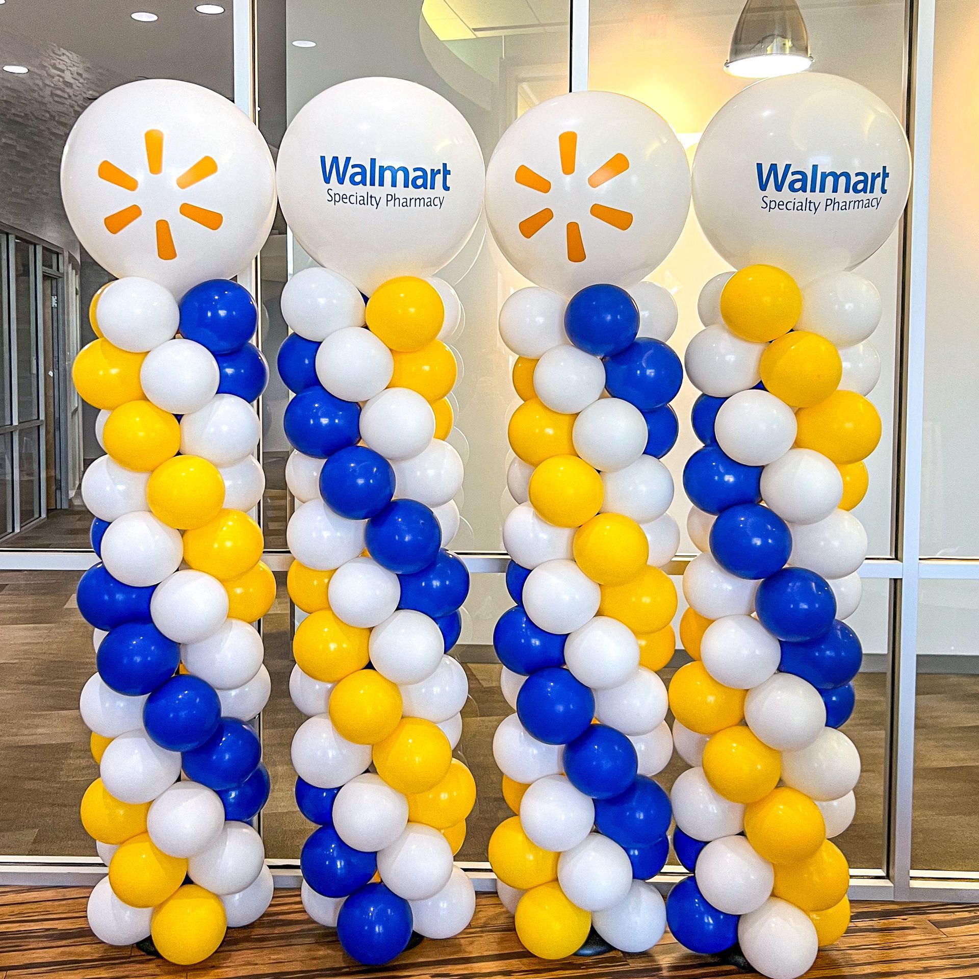 three columns of blue and yellow balloons with walmart logos on them