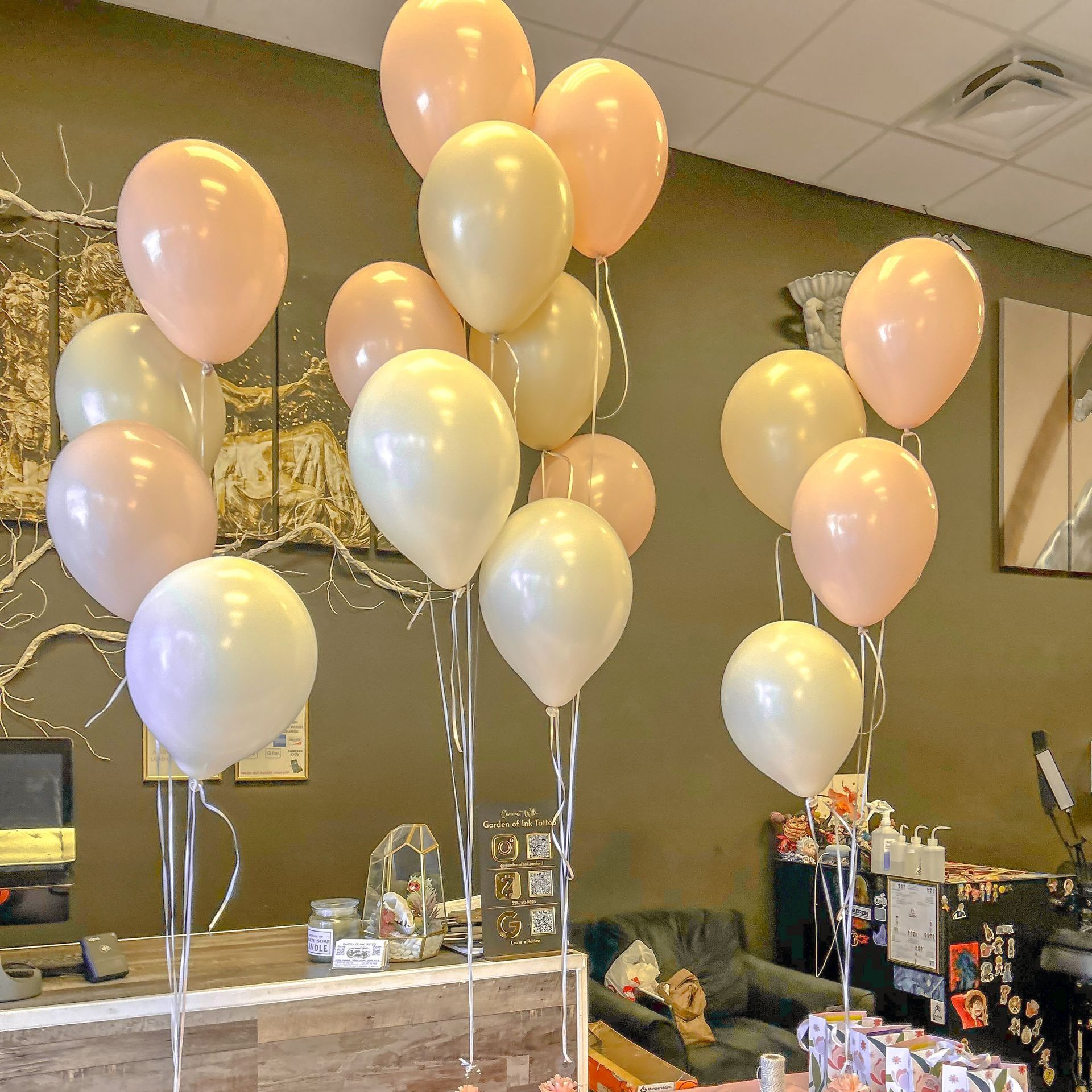A bunch of balloons are hanging from the ceiling in a room