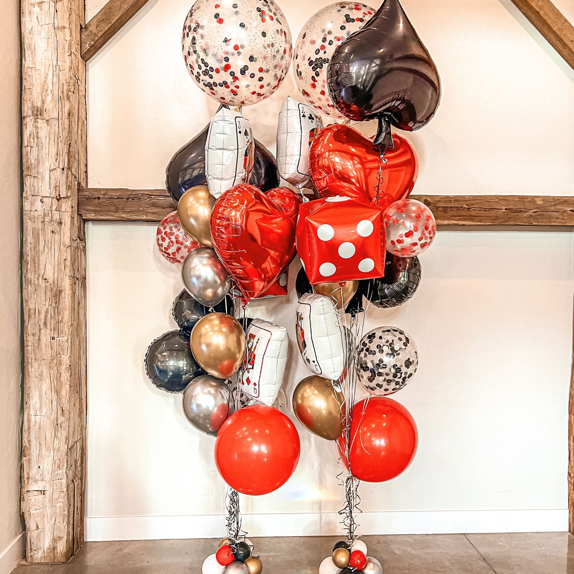 a bunch of balloons are stacked on top of each other in a room .