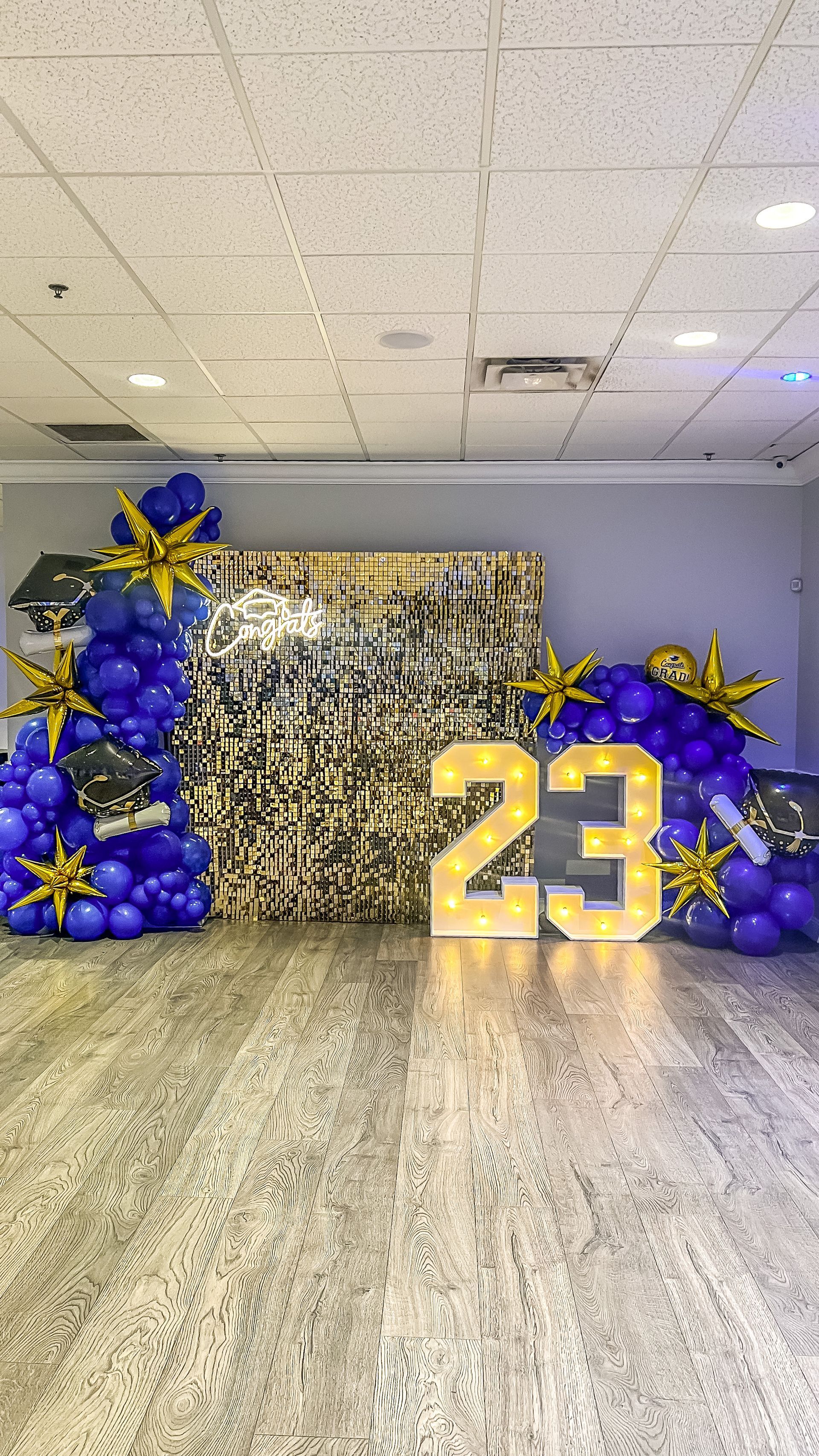 A room filled with balloons and a sign that says `` 23 ''.