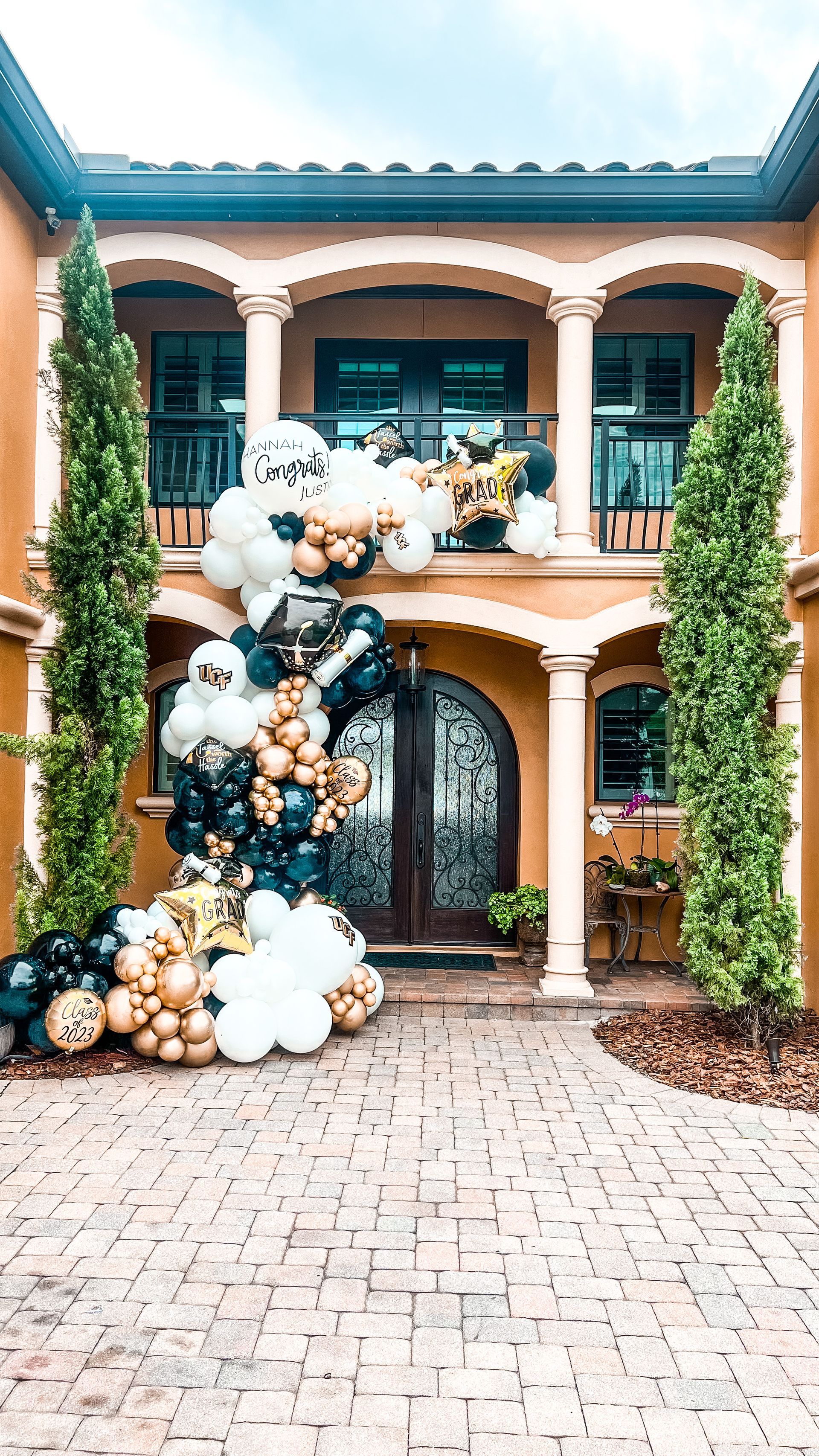 A large house with a bunch of balloons in front of it.