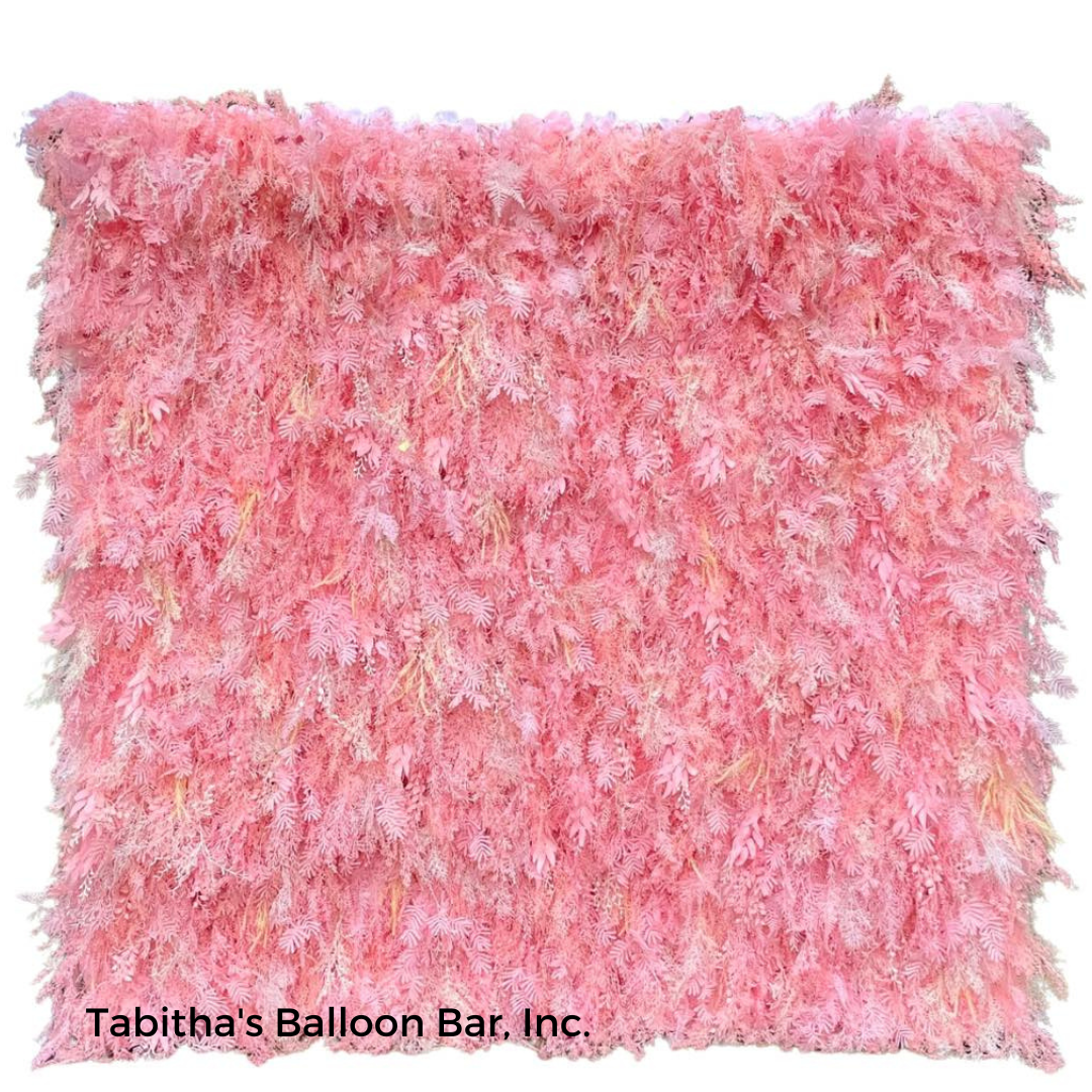 a pink pillow with feathers on it is from tabitha 's balloon bar inc.