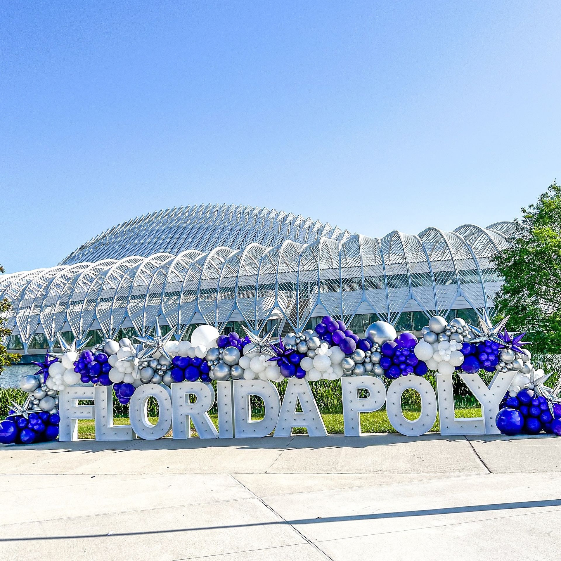 A bunch of blue and gold balloons are sitting on the floor.