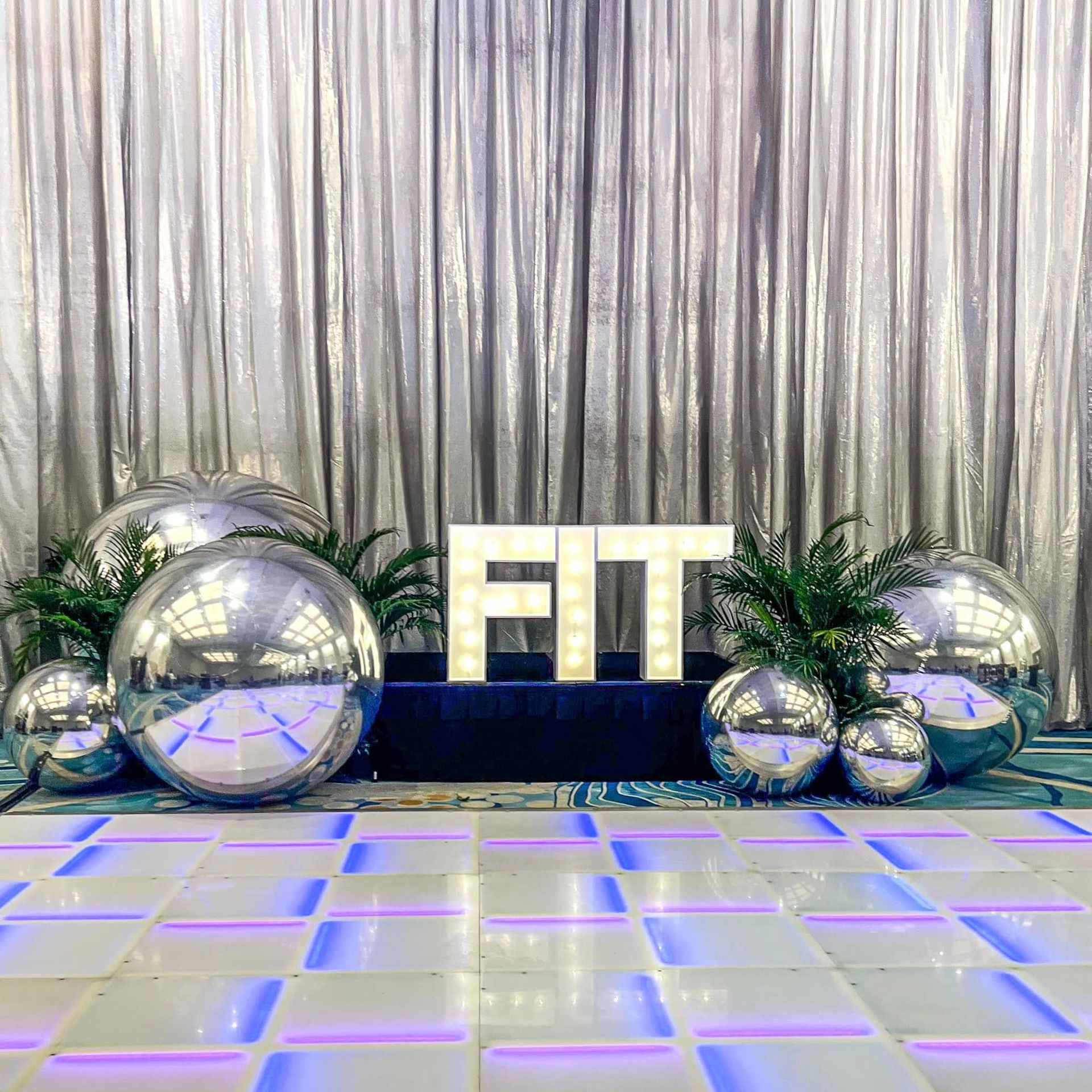 There is a dance floor with a sign that says `` fit '' on it.