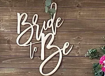 a wooden sign that says `` bride to be '' on a wooden wall .