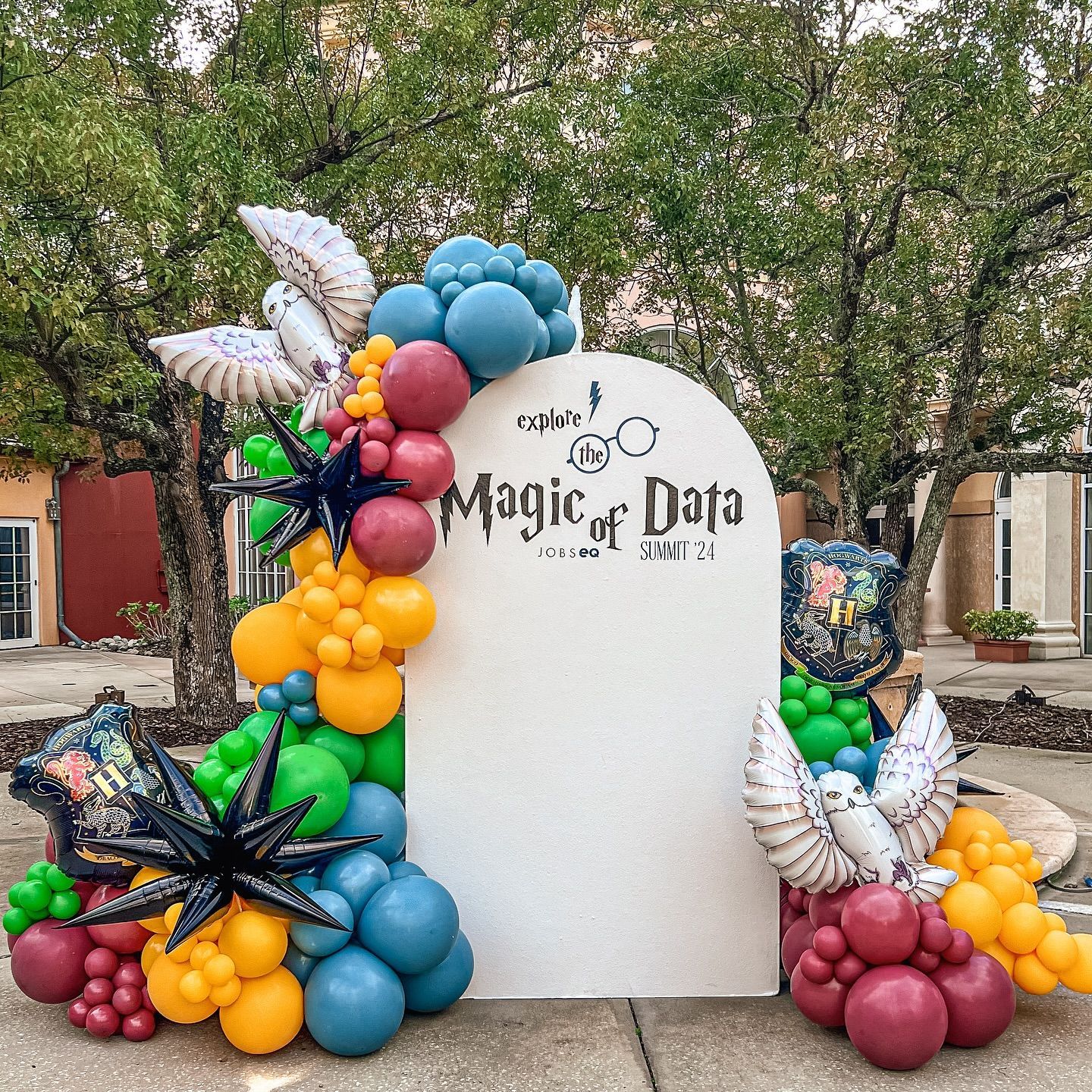 A sign with balloons on it that says `` magic of data ''
