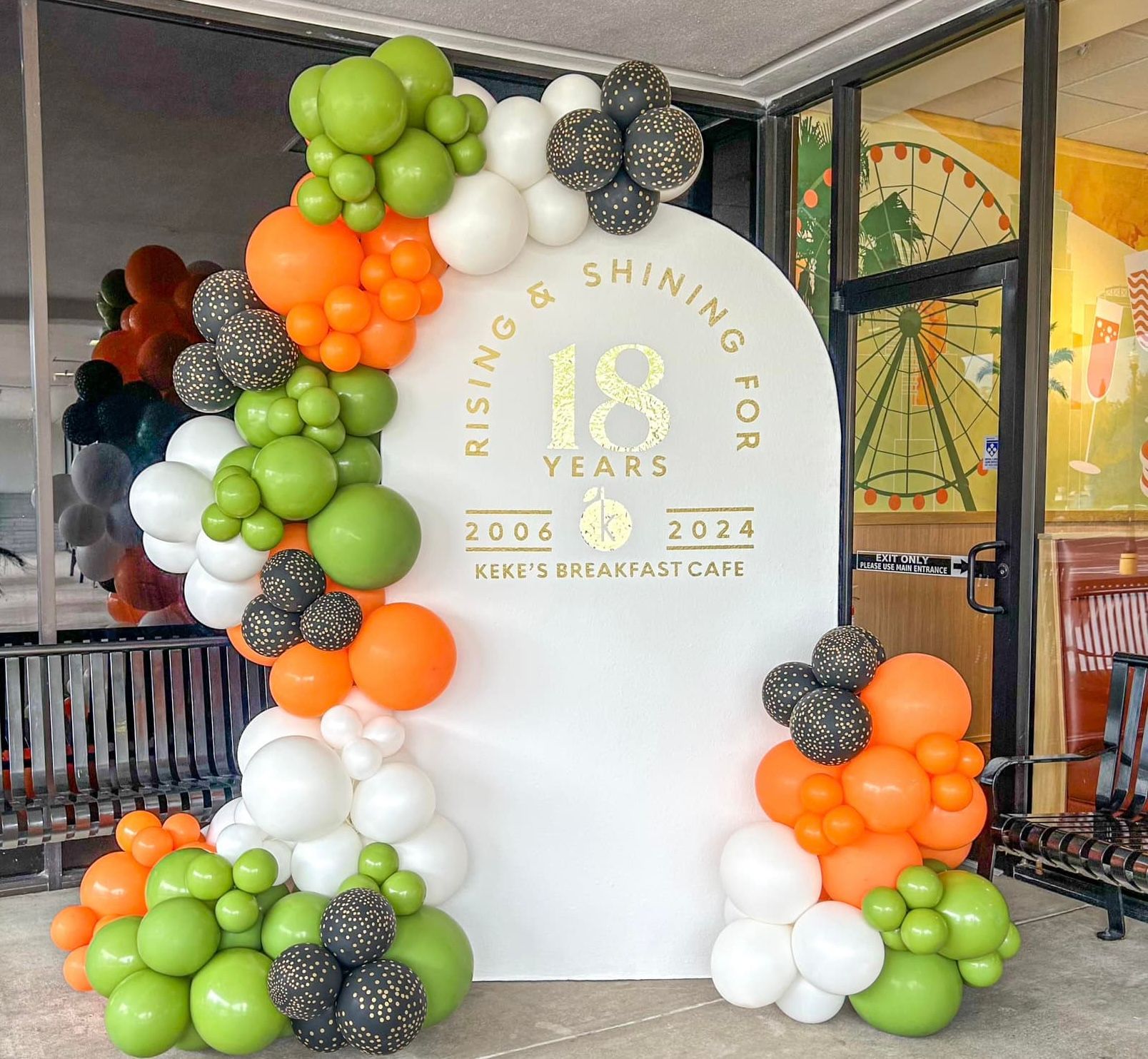 A stage decorated with balloons and gifts for a party.