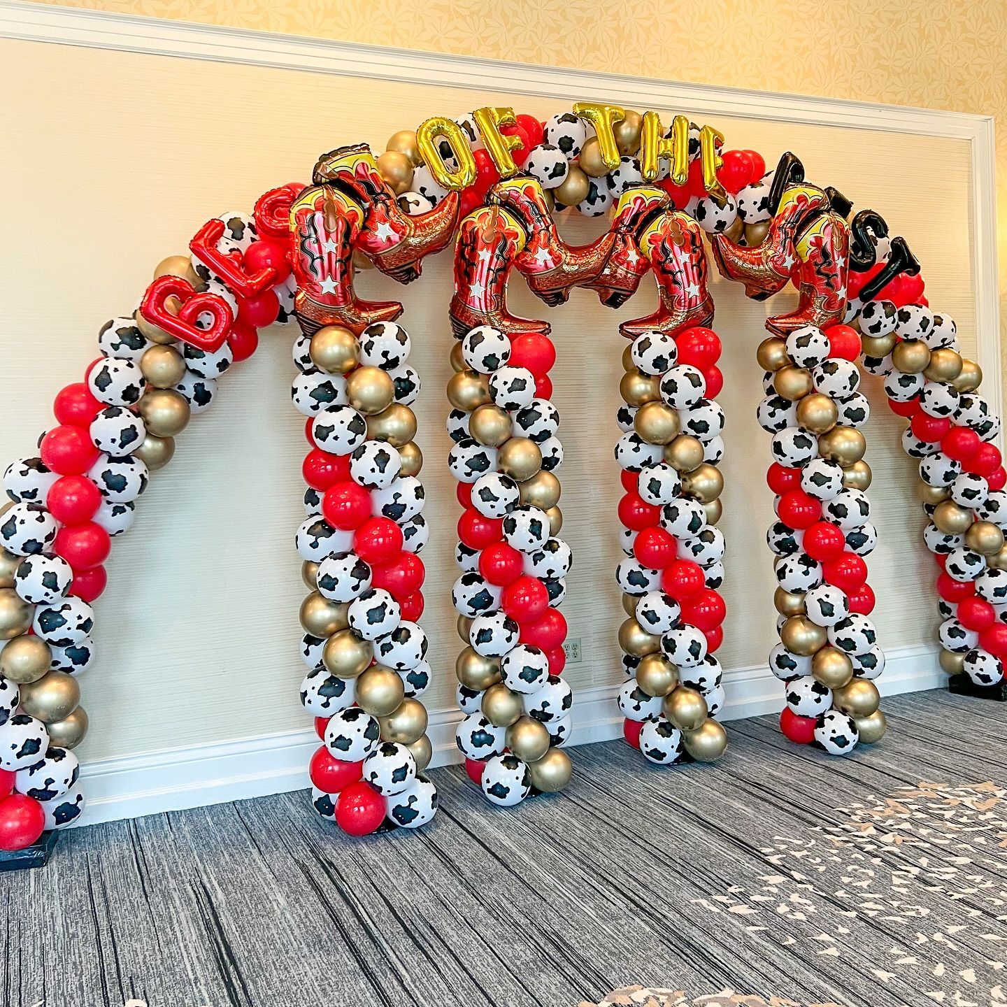 A large arch made of balloons in a room.