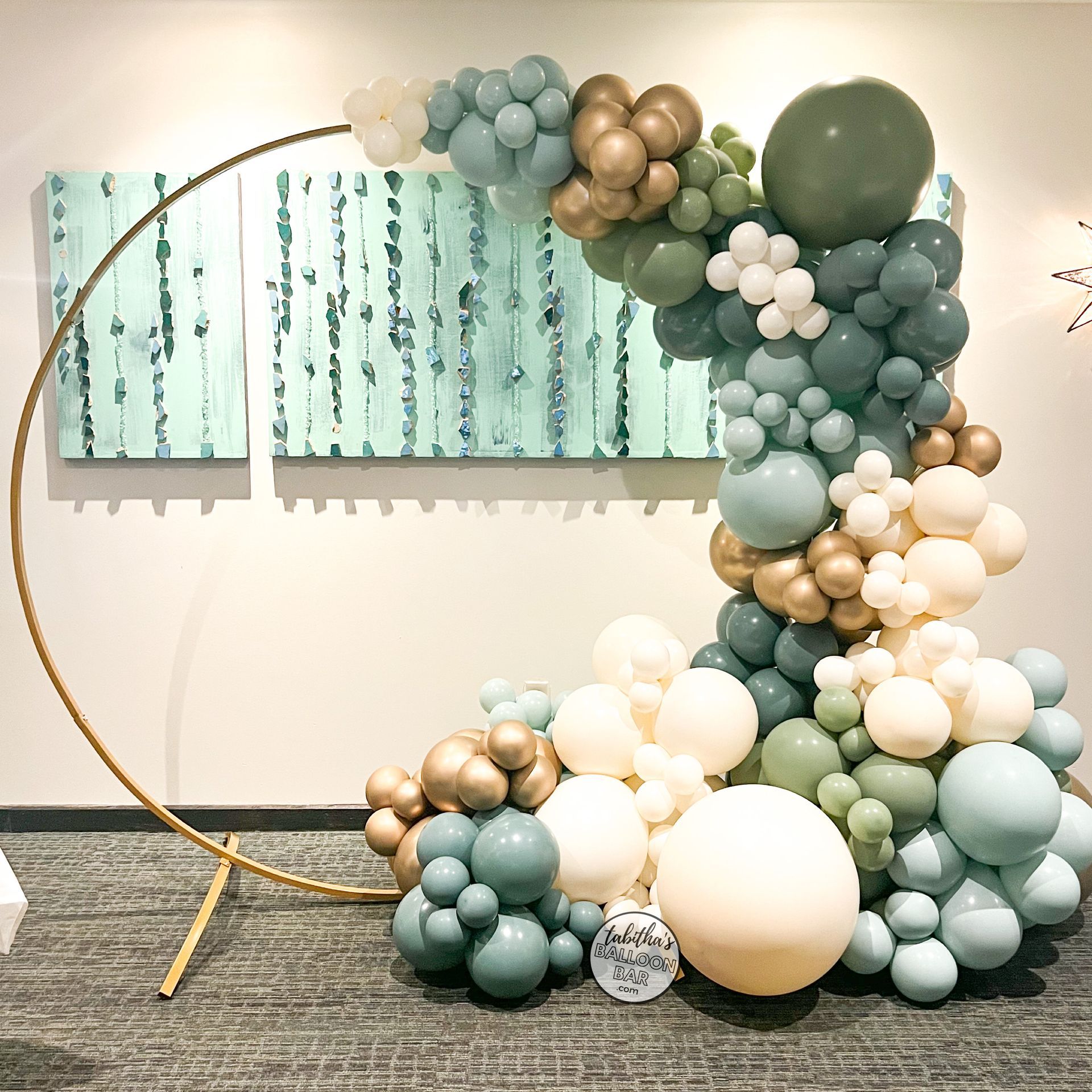 A bunch of balloons are sitting on the floor in front of a wall.