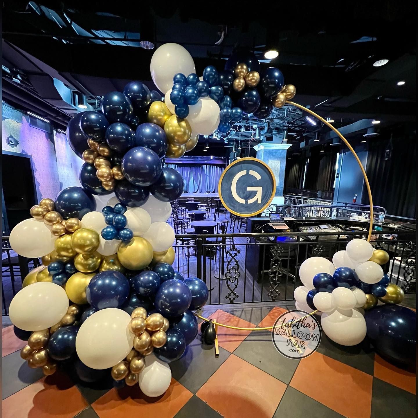 a bunch of balloons are sitting on a checkered floor in a room .