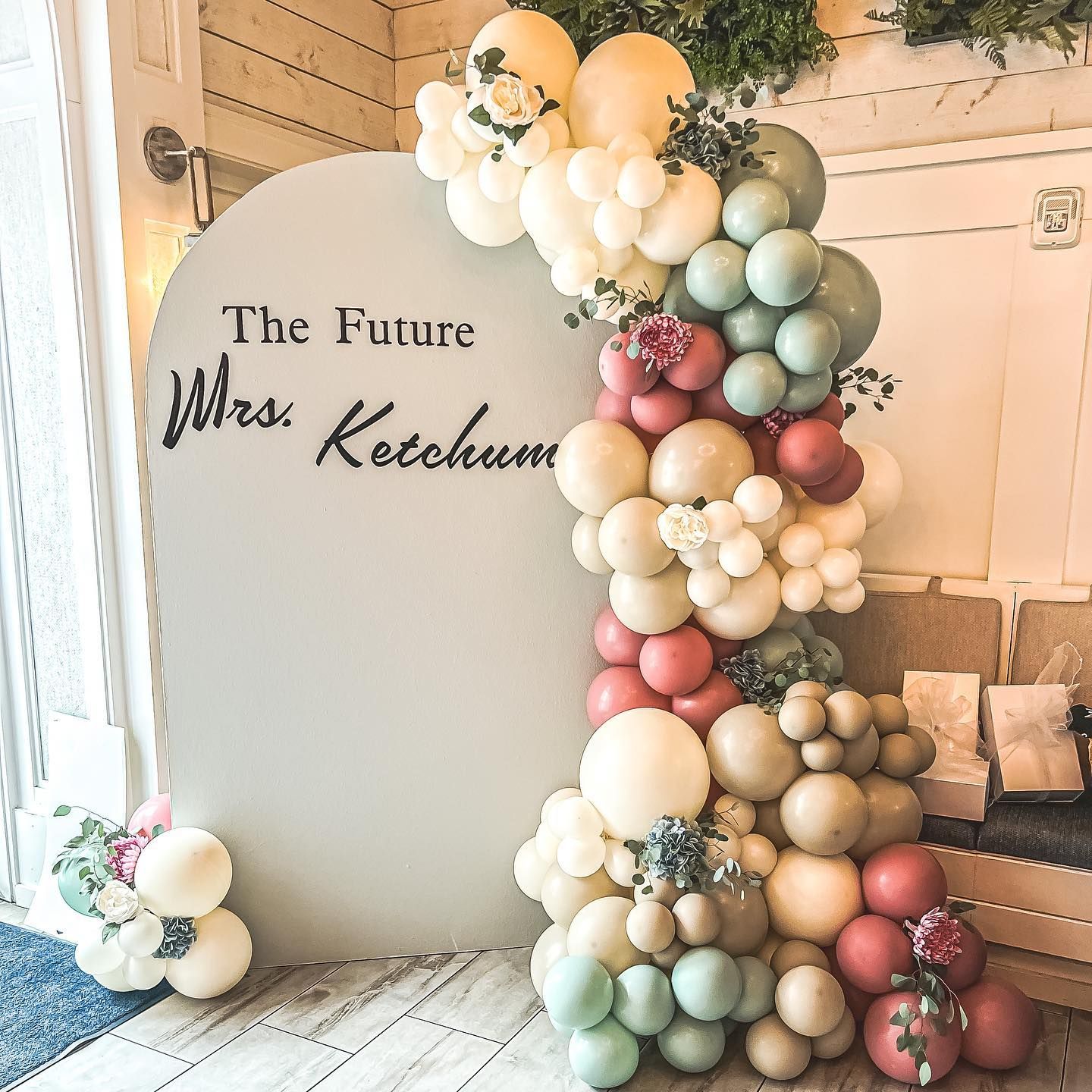 A bunch of balloons are sitting in front of a sign that says `` the future mrs. ketchum ''.